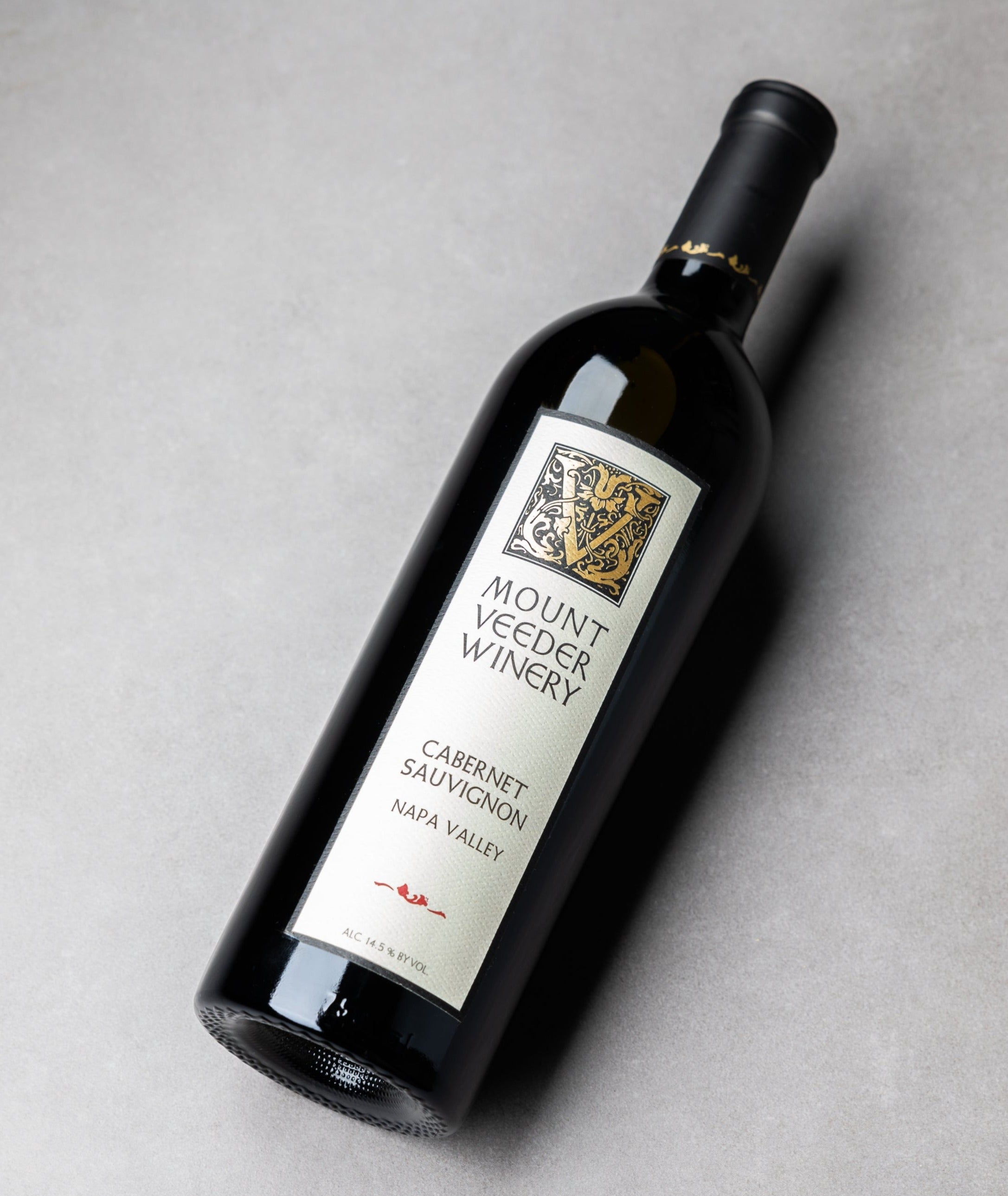 A bottle of 2021 Mount Veeder Cabernet Sauvignon Napa Valley laying on a tabletop, label up