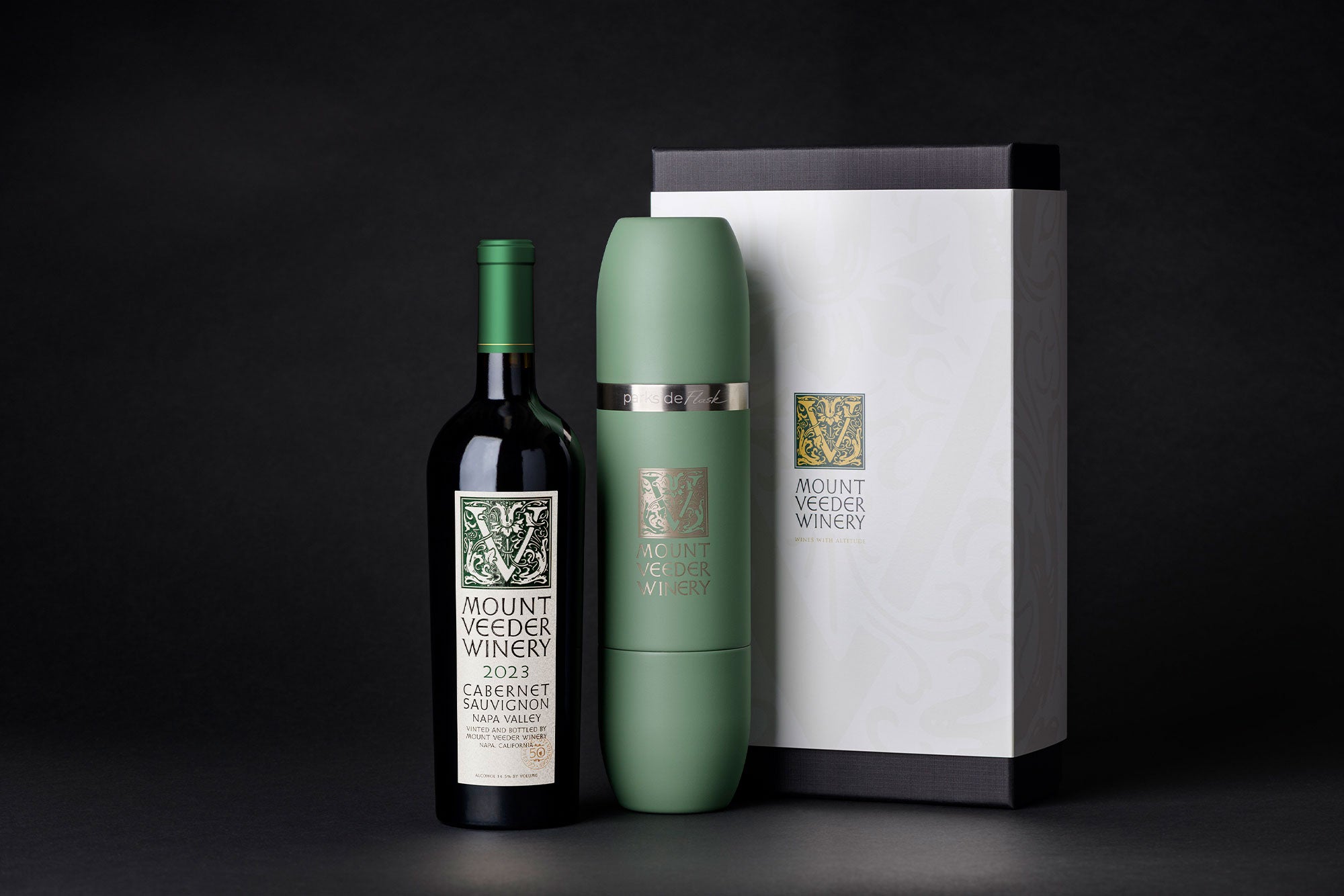 Wine bottle, green Parkside flask, and gift box with 'Mount Veeder Winery' branding on a black background.